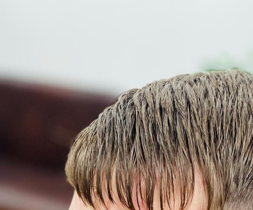 A blunt fringe left heavy on top with the sides taken much shorter underneath.