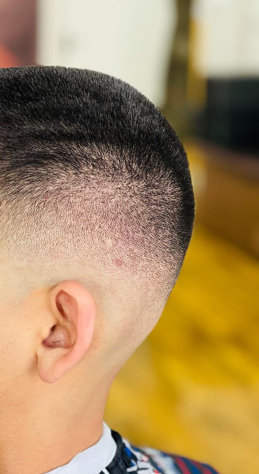 A high fade taken down to the skin above the ear and blended up into the length on top.